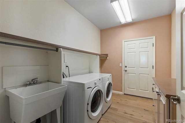 1901 S Union Pl, Lakewood, CO 80228 - laundry area with washing machine and clothes dryer and light wood-style floors