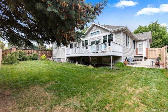 1901 S Union Pl, Lakewood, CO 80228 - back of property featuring a deck, a patio, a fenced backyard, and a shingled roof
