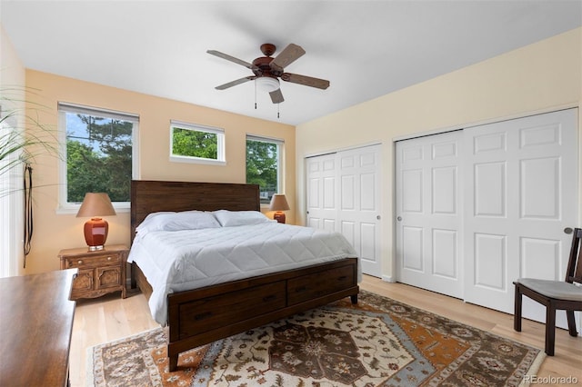 1901 S Union Pl, Lakewood, CO 80228 - bedroom featuring multiple closets, light wood finished floors, and a ceiling fan