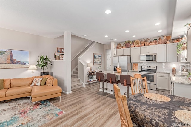 4790 Kittredge St, Denver, CO 80239 - dining area with stairway, recessed lighting, and light wood-type flooring
