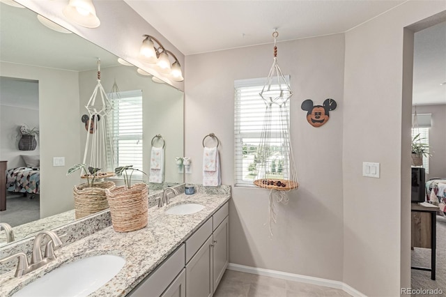 4790 Kittredge St, Denver, CO 80239 - ensuite bathroom featuring double vanity and baseboards