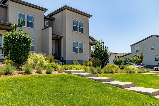 4790 Kittredge St, Denver, CO 80239 - contemporary home with a front yard and stucco siding