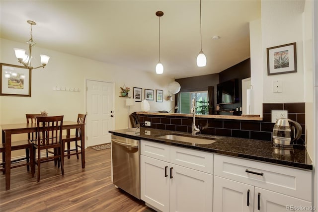 2430 W 82nd Pl Unit 2F, Westminster, CO 80031 - kitchen with dishwasher, a sink, tasteful backsplash, and dark wood-style floors