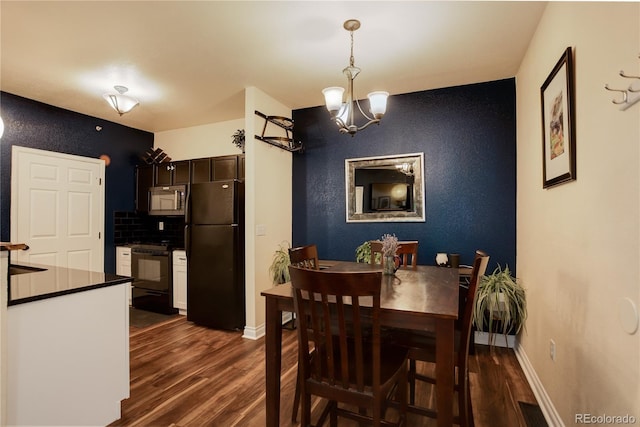 2430 W 82nd Pl Unit 2F, Westminster, CO 80031 - dining space with dark wood-type flooring and a chandelier