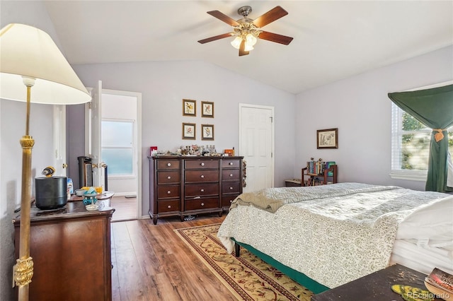 bedroom with lofted ceiling, dark hardwood / wood-style flooring, and ceiling fan