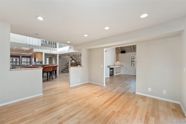 living area featuring stairway, recessed lighting, wood finished floors, and baseboards