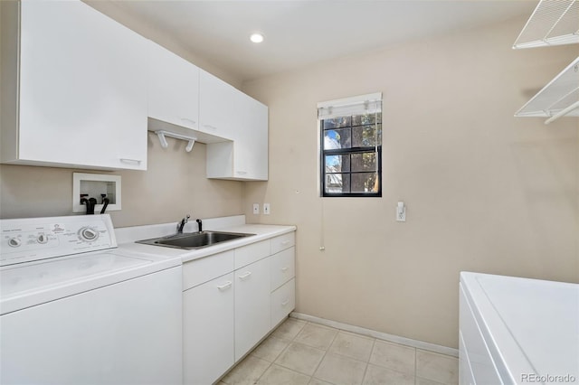 laundry area with visible vents, a sink, washer / clothes dryer, cabinet space, and baseboards