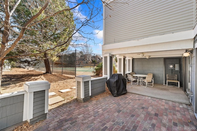 view of patio / terrace with grilling area, outdoor dining area, and fence