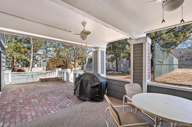 view of patio / terrace featuring a grill, ceiling fan, and fence