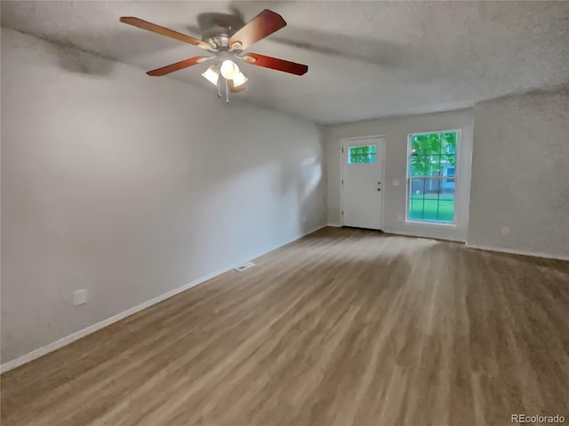 unfurnished living room featuring ceiling fan and light hardwood / wood-style floors