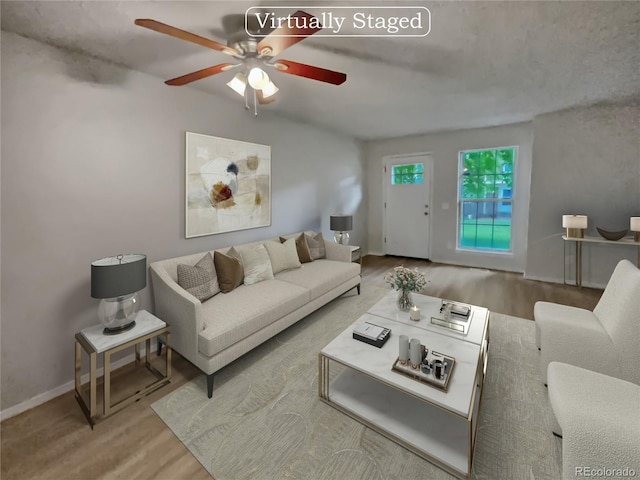 living room featuring ceiling fan and light hardwood / wood-style floors