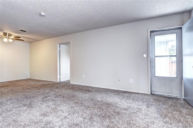 unfurnished room with visible vents, a ceiling fan, a textured ceiling, and carpet flooring
