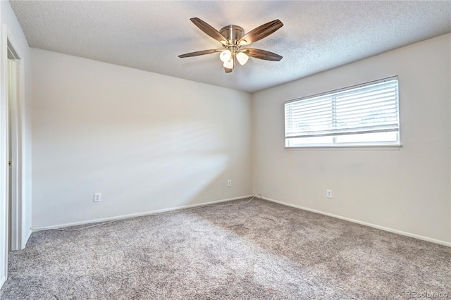unfurnished room with a textured ceiling, ceiling fan, baseboards, and carpet