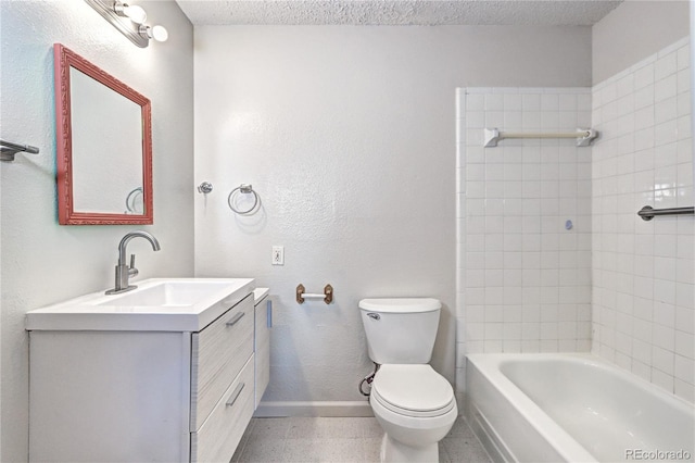 full bathroom featuring baseboards, vanity, toilet, and a textured ceiling