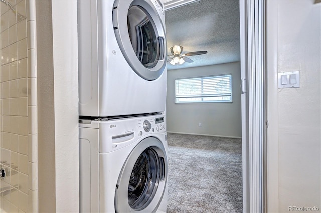 clothes washing area featuring carpet flooring, stacked washer and dryer, laundry area, a ceiling fan, and baseboards