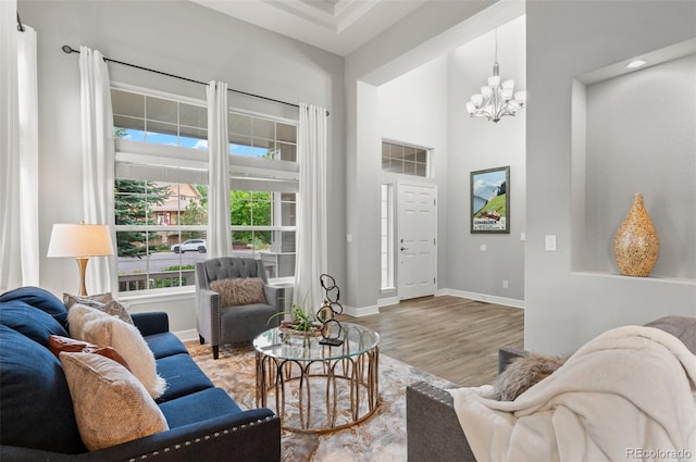 3041 Starling Ct, Castle Rock, CO 80109 - living area with wood finished floors, a chandelier, baseboards, and a towering ceiling