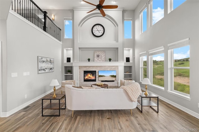 3041 Starling Ct, Castle Rock, CO 80109 - living room with baseboards, built in features, healthy amount of natural light, and a towering ceiling