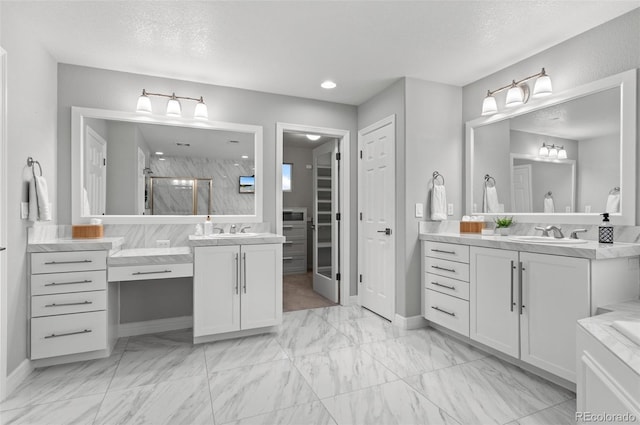 3041 Starling Ct, Castle Rock, CO 80109 - full bath featuring a stall shower, two vanities, marble look tile flooring, baseboards, and a textured ceiling