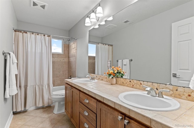3041 Starling Ct, Castle Rock, CO 80109 - bathroom featuring double vanity, shower / bath combo with shower curtain, toilet, and tile patterned flooring