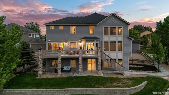 3041 Starling Ct, Castle Rock, CO 80109 - back of house at dusk featuring a patio, stairway, and a deck