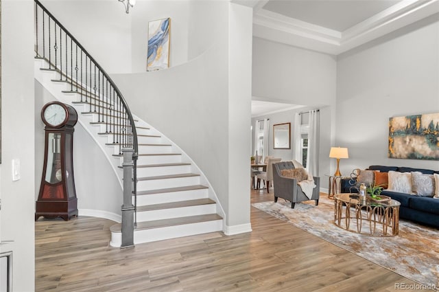 3041 Starling Ct, Castle Rock, CO 80109 - living room featuring a high ceiling, stairway, wood finished floors, and baseboards