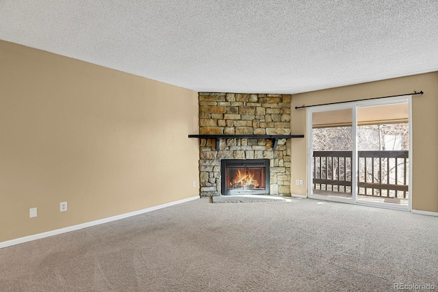 unfurnished living room with a stone fireplace, carpet floors, and a textured ceiling