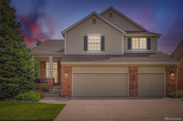 2561 Cactus Bluff Pl, Highlands Ranch, CO 80129 - view of front facade featuring brick siding, an attached garage, driveway, and a shingled roof
