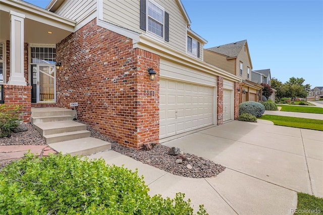 2561 Cactus Bluff Pl, Highlands Ranch, CO 80129 - view of property exterior with brick siding, an attached garage, and driveway