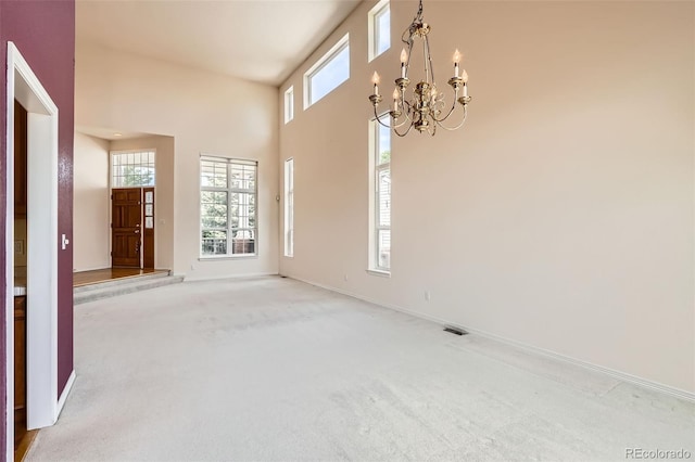 2561 Cactus Bluff Pl, Highlands Ranch, CO 80129 - entrance foyer featuring plenty of natural light, a chandelier, carpet, and a towering ceiling