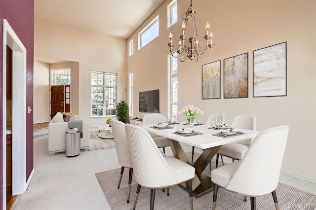 2561 Cactus Bluff Pl, Highlands Ranch, CO 80129 - dining room with a chandelier, a high ceiling, and light colored carpet