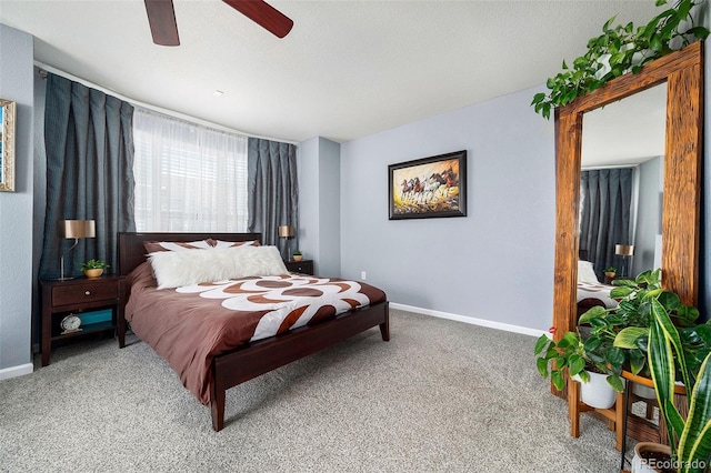 carpeted bedroom with a ceiling fan and baseboards