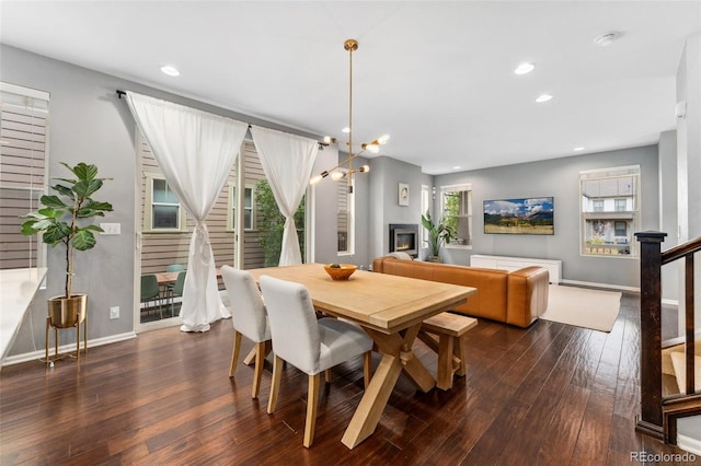 dining room featuring dark hardwood / wood-style flooring and a notable chandelier