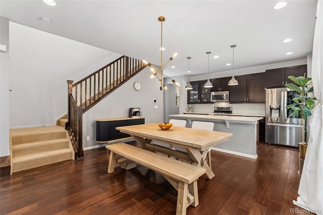 dining space featuring dark hardwood / wood-style floors and a notable chandelier