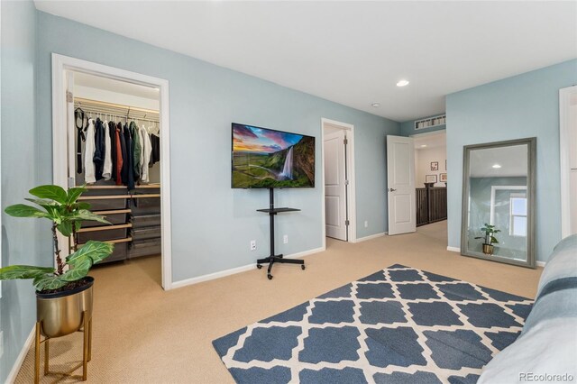 bedroom with carpet, a walk in closet, and a closet