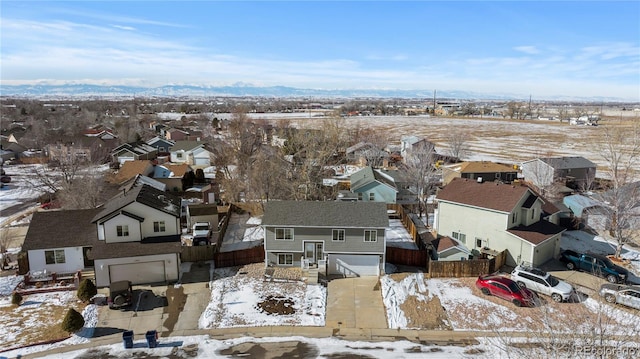 snowy aerial view with a residential view