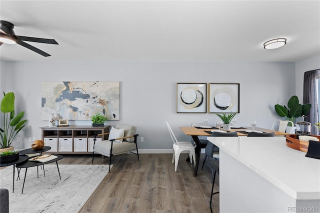 office featuring a ceiling fan, baseboards, and wood finished floors