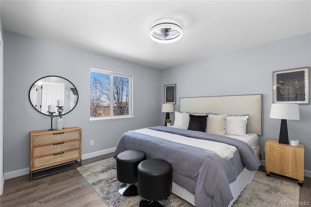 bedroom featuring baseboards and wood finished floors