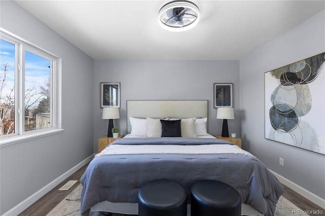 bedroom with wood finished floors and baseboards