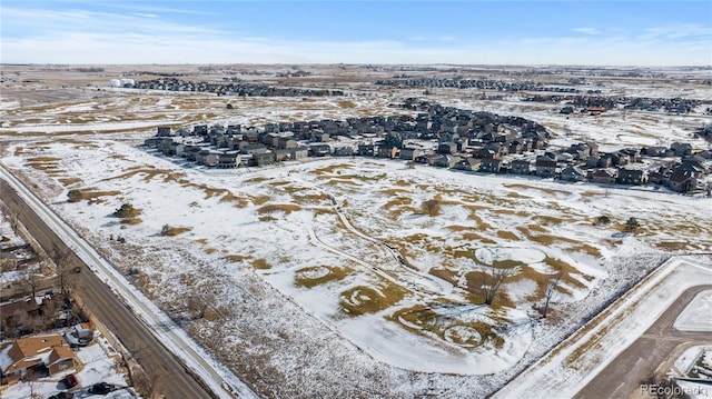 snowy aerial view featuring a residential view