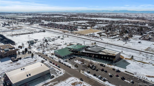 snowy aerial view with a mountain view