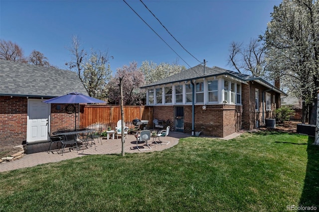 285 S Williams St, Denver, CO 80209 - rear view of property with a patio, a yard, fence, and brick siding