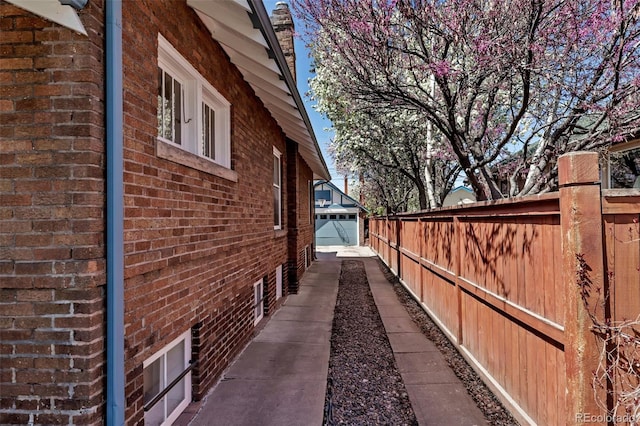 285 S Williams St, Denver, CO 80209 - view of home's exterior featuring brick siding, an outdoor structure, and fence