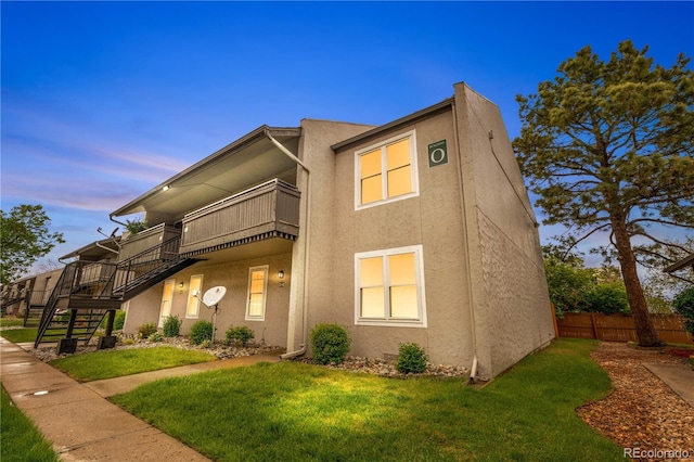 7110 S Gaylord St Unit O7, Centennial, CO 80122 - view of side of property featuring stairs, stucco siding, and a balcony