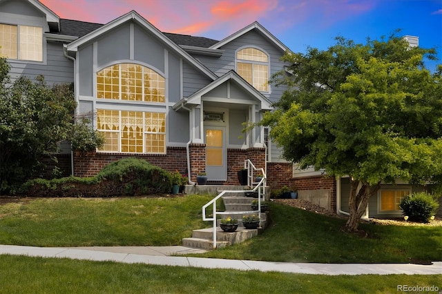 18489 E Columbia Cir, Aurora, CO 80013 - view of front of property featuring brick siding and a front lawn