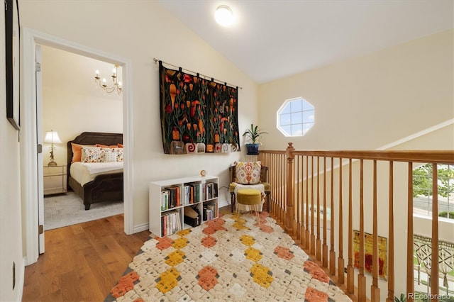 18489 E Columbia Cir, Aurora, CO 80013 - living area with lofted ceiling, wood finished floors, and a chandelier
