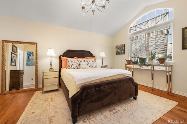 18489 E Columbia Cir, Aurora, CO 80013 - bedroom featuring vaulted ceiling, wood finished floors, and a chandelier