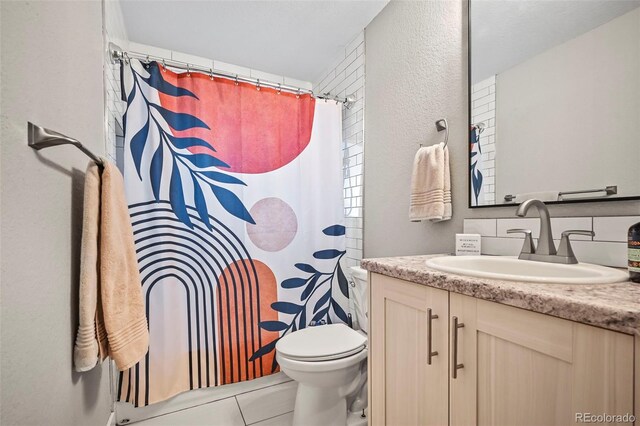 bathroom featuring curtained shower, vanity, toilet, and tile patterned floors