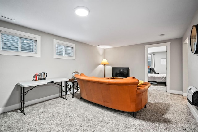 carpeted living area with visible vents and baseboards