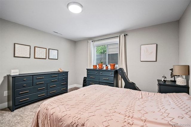 carpeted bedroom with visible vents and baseboards