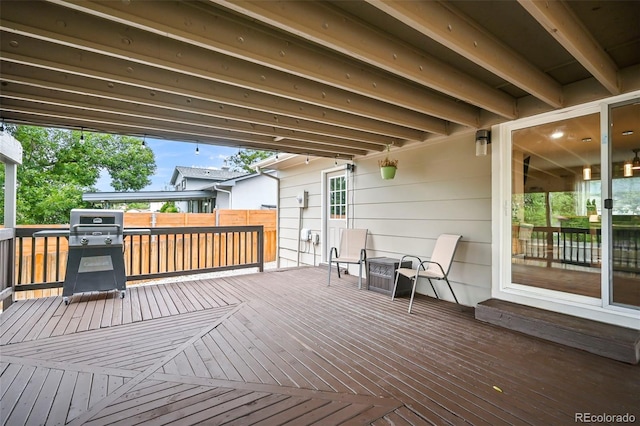 wooden terrace with area for grilling and fence